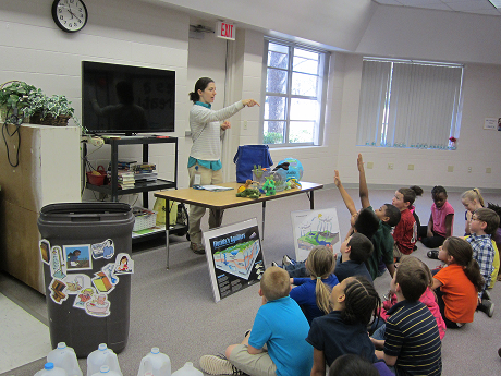 Children raising their hands in a classroom