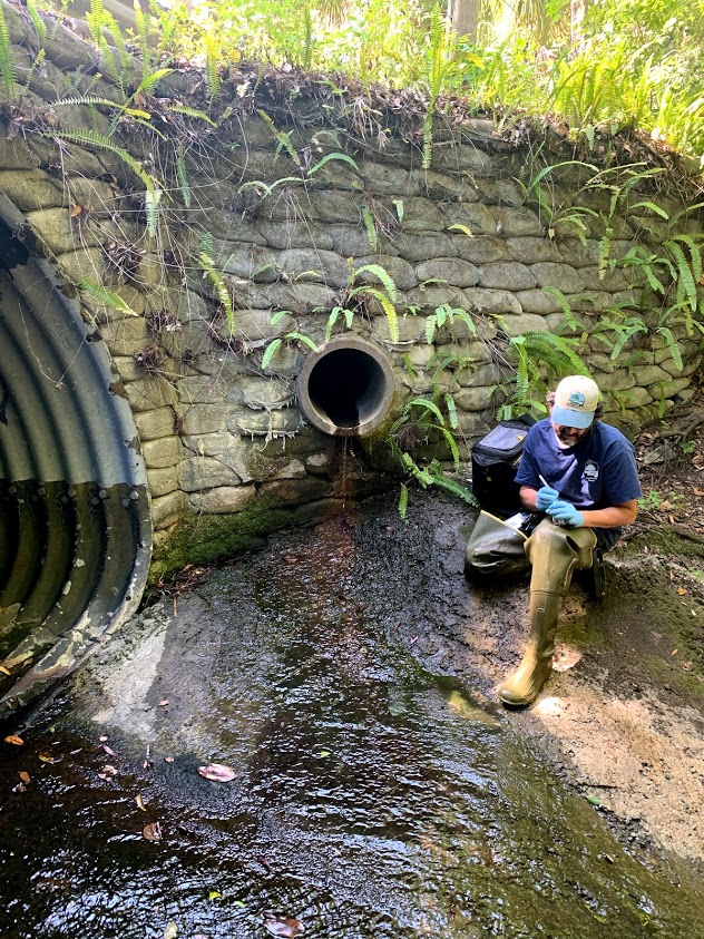 Person monitoring water quality in surface water